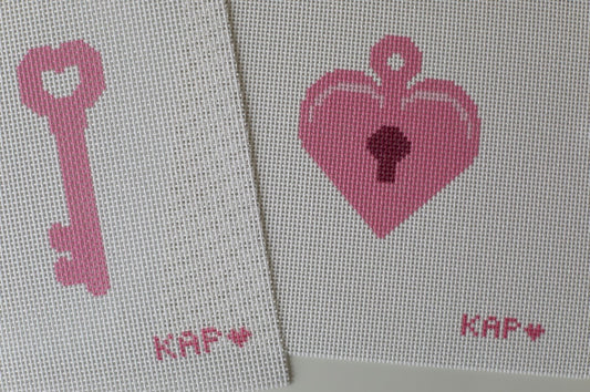 Close-up detail of Mommy and Me needlepoint locket and key canvas set