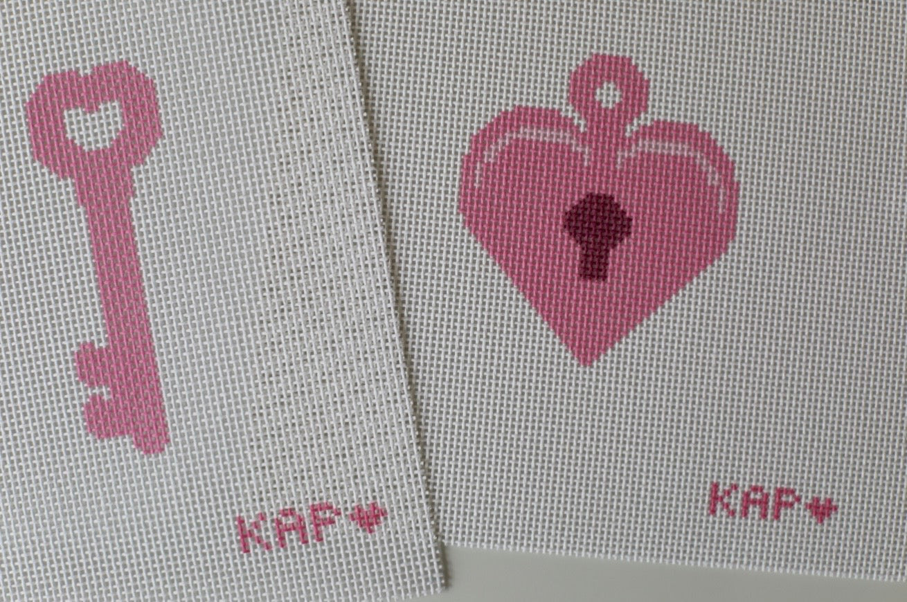Close-up detail of Mommy and Me needlepoint locket and key canvas set